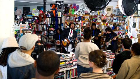 bartees strange performing with his band in an NPR office